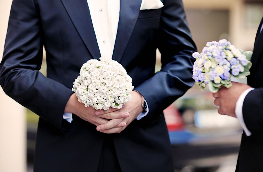 Grooms carrying bouquets